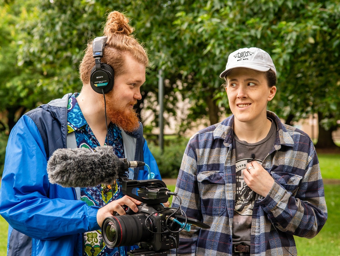 two students with camera recording equipment