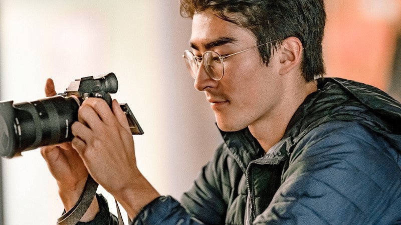 a student looks at the preview screen on a DSLR camera