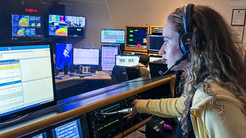 a student works as a producer at a news station