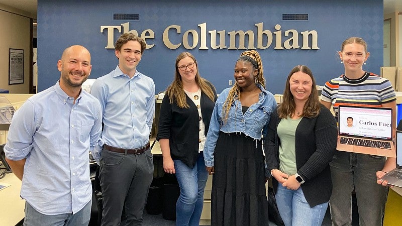 group of Snowden program alums who now work at The Columbian pose in the newsroom