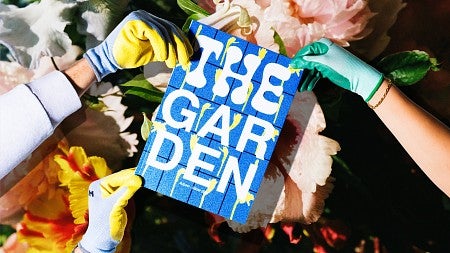 hands wearing gardening gloves hold a copy of The Garden, a magazine portfolio project by Charlie Nguyen 