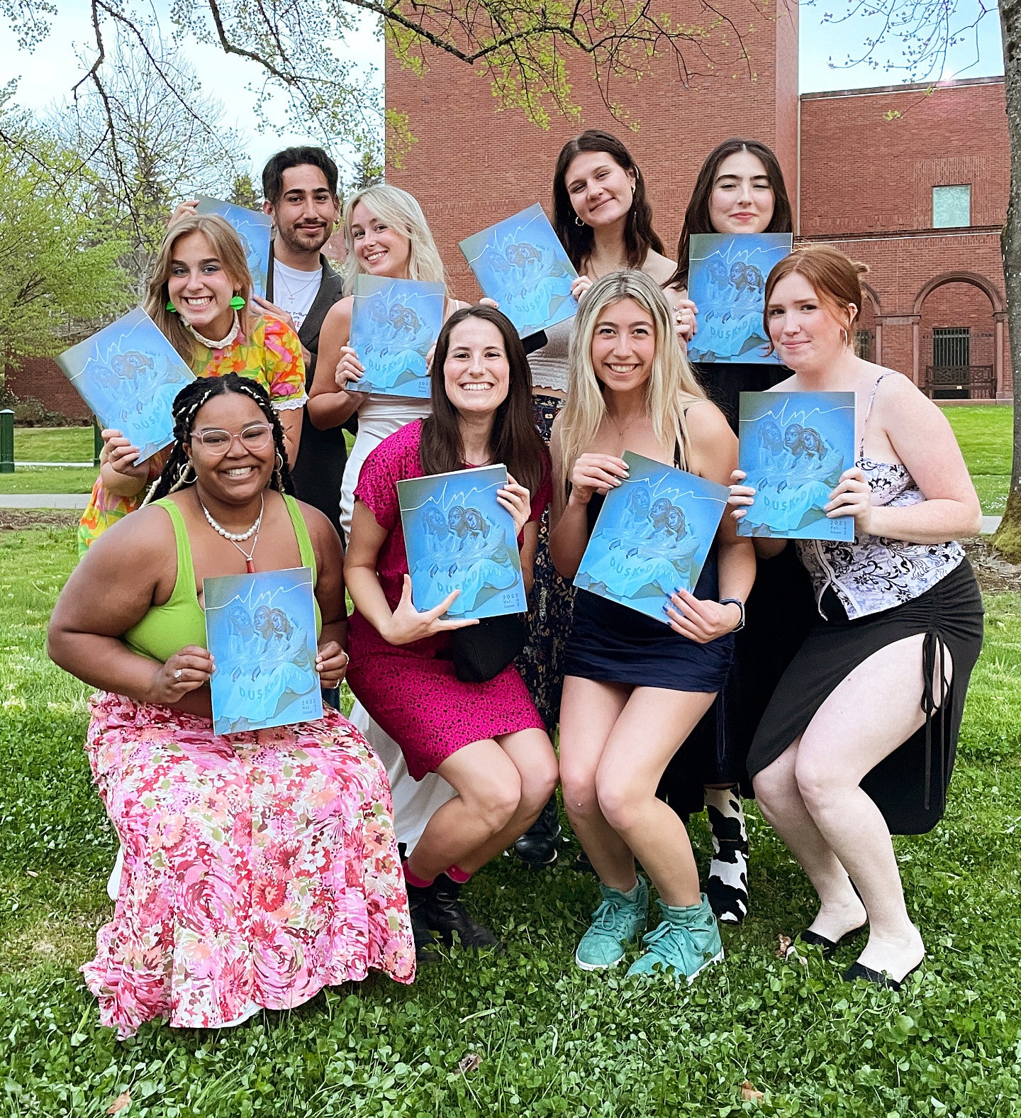 Ten students holding copies of the Align print magazine