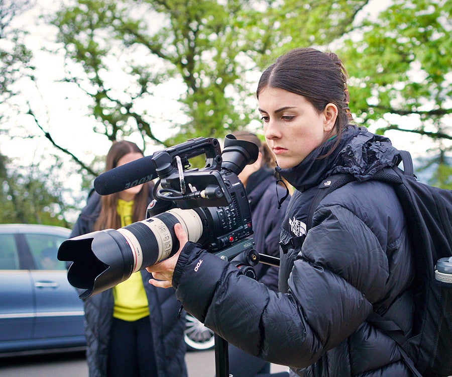 a student films with a video camera