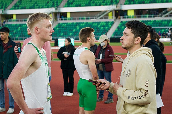 an SOJC Track Bureau student interviews an athlete at Hayward Field