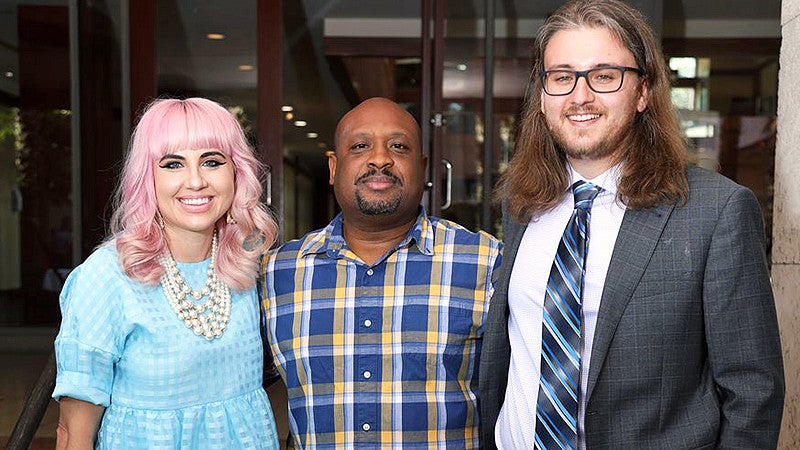 Rebecca Woolington, Corey G. Johnson and Eli Murray pose for a picture