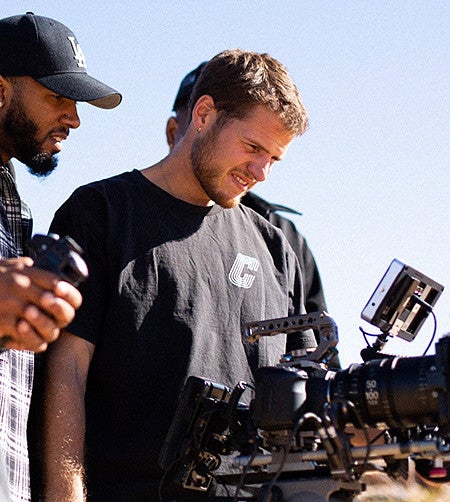 Sutton Raphael looks into a video camera display