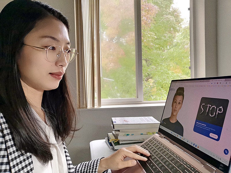 Tingyou Zou works at a laptop