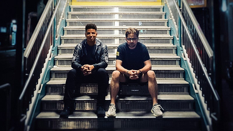 Tommy Woods and Jacobi Mehringer sit on metal steps