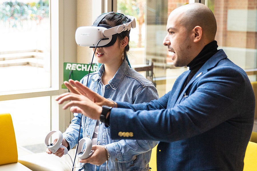 Danny Pimentel instructs a student wearing a VR headset