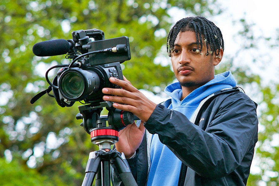 a student films with a video camera