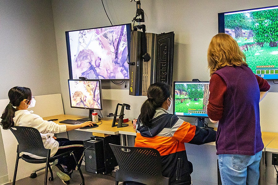 students use computers in the Immersive Media Lab in Allen Hall