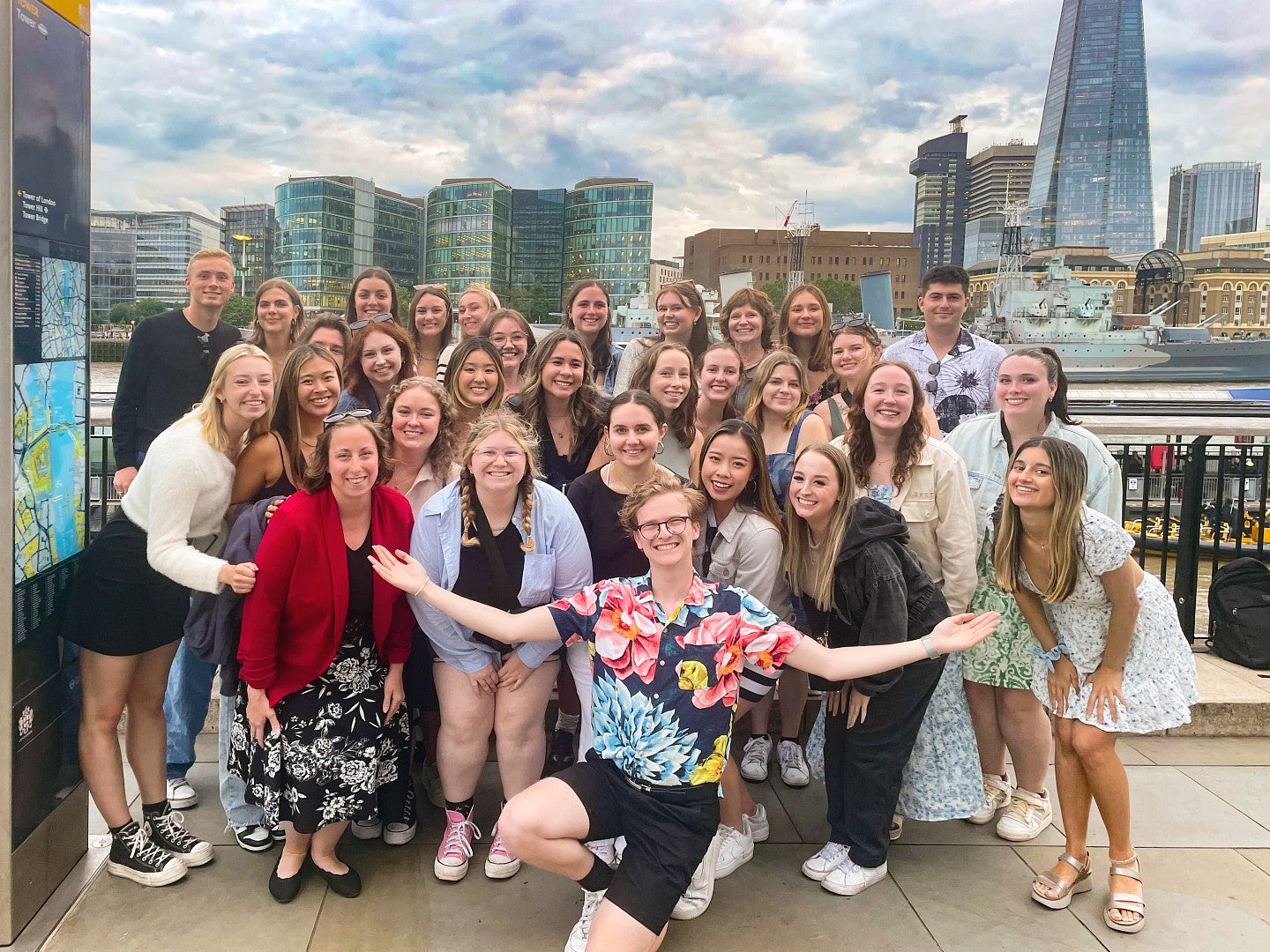 large group of students posing in front of London's skyline