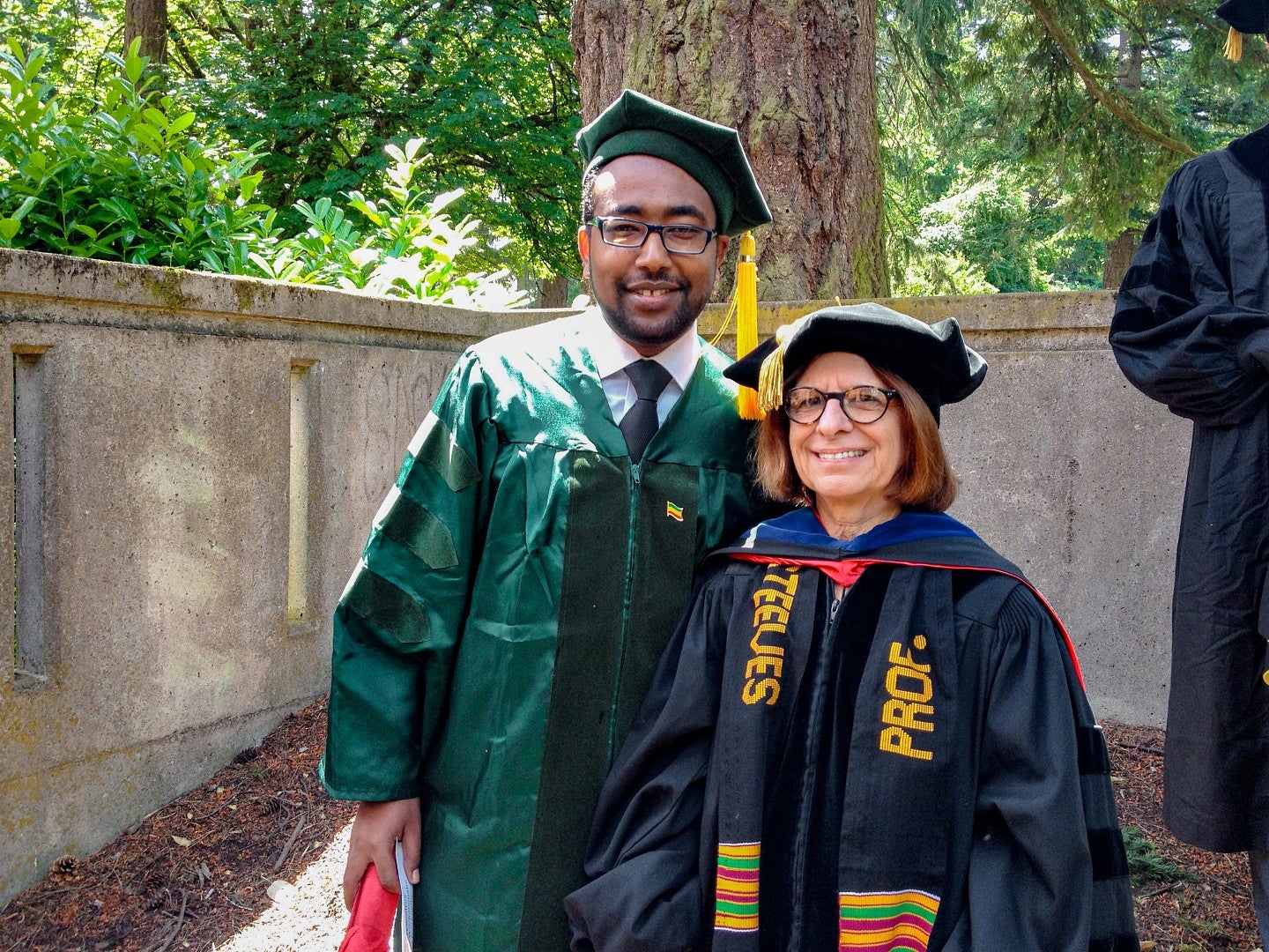 Teddy Workneh and Leslie Steeves in commencement regalia