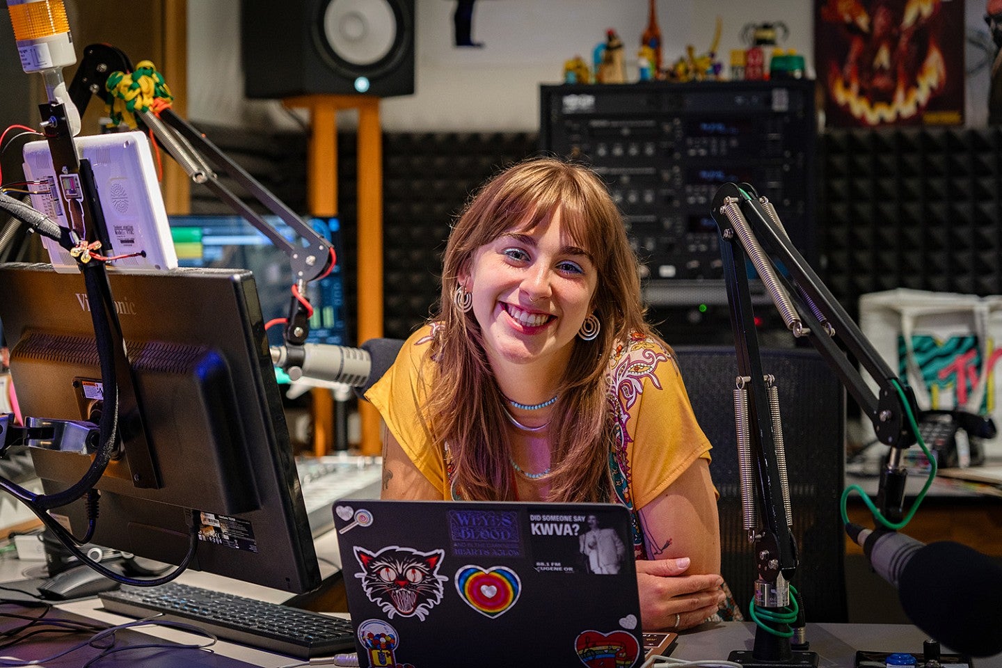 portrait of Kayla Krueger at the DJ desk at KWVA radio