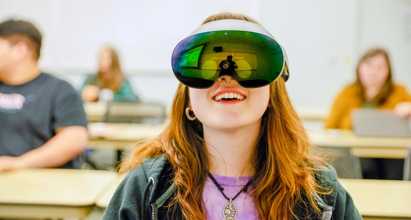 a person wearing a VR headset with a vibrantly colored reflective surface
