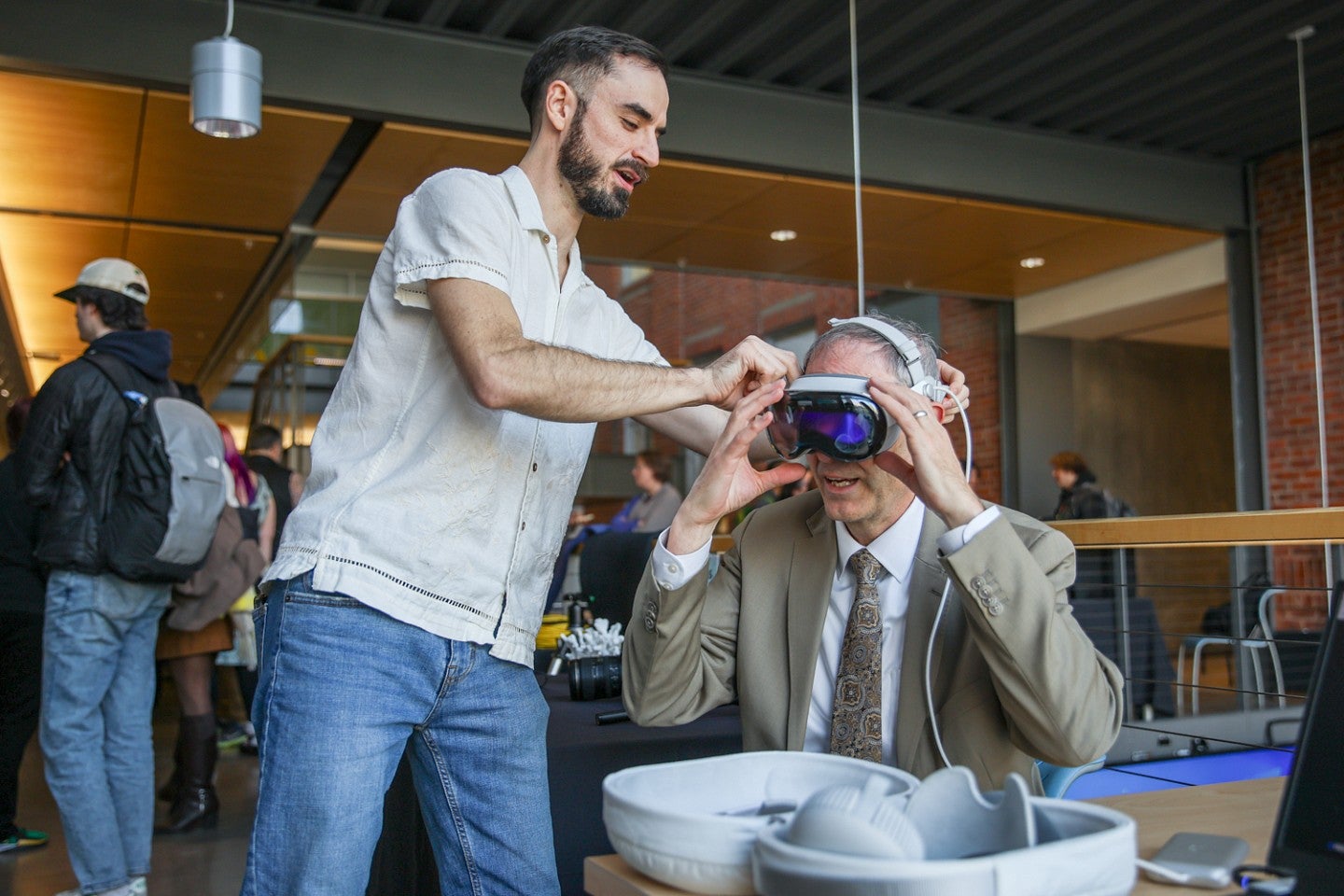 Sam Morrison helps University of Oregon Provost Chris Long put on VR goggles