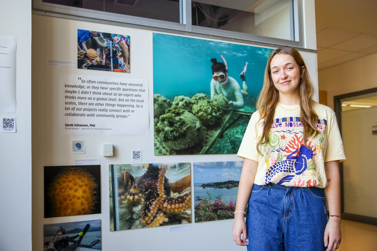 Bea Mira poses next to a display of her photography