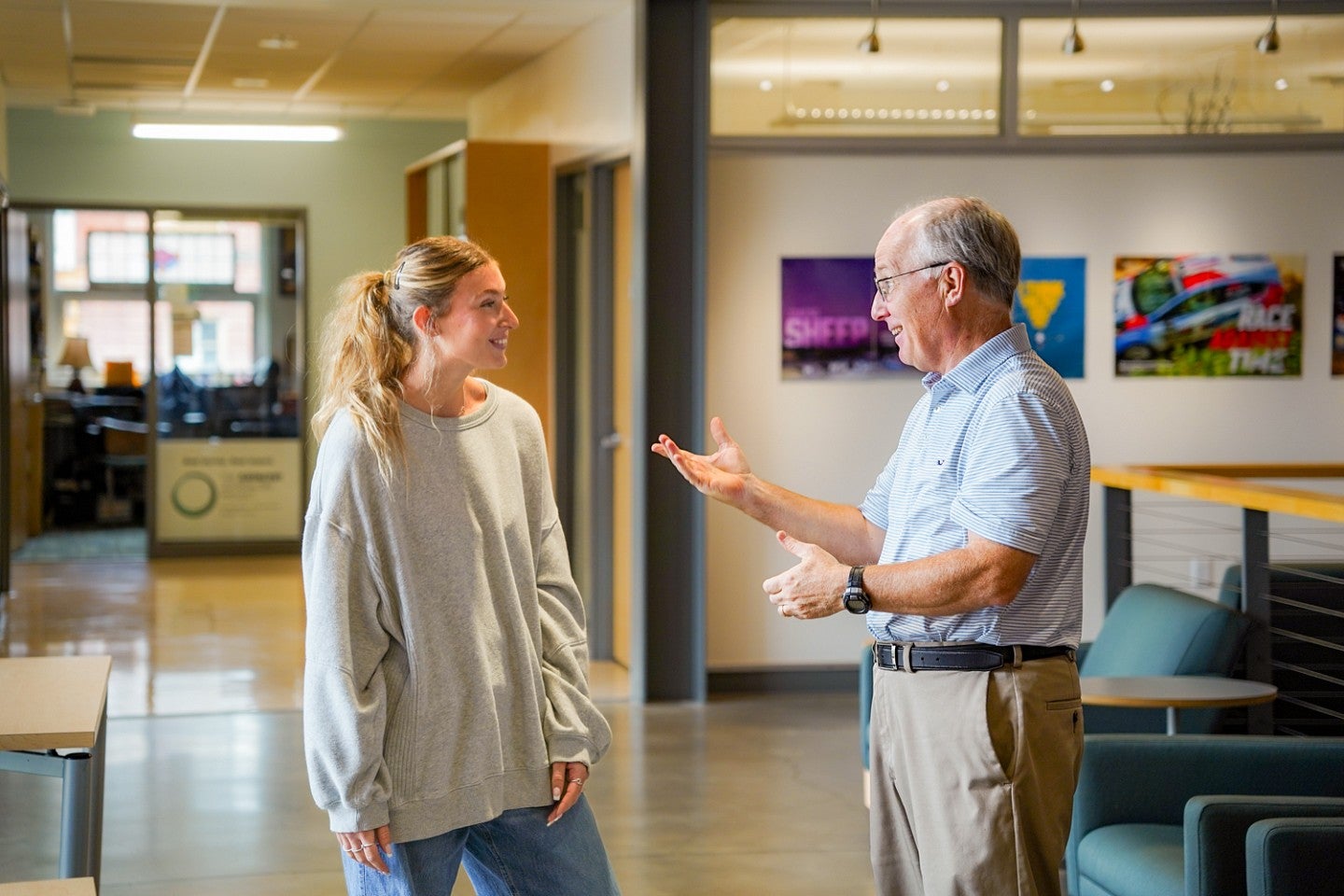 Ella Pinn and Charlie Butler chat in the atrium of Allen Hall