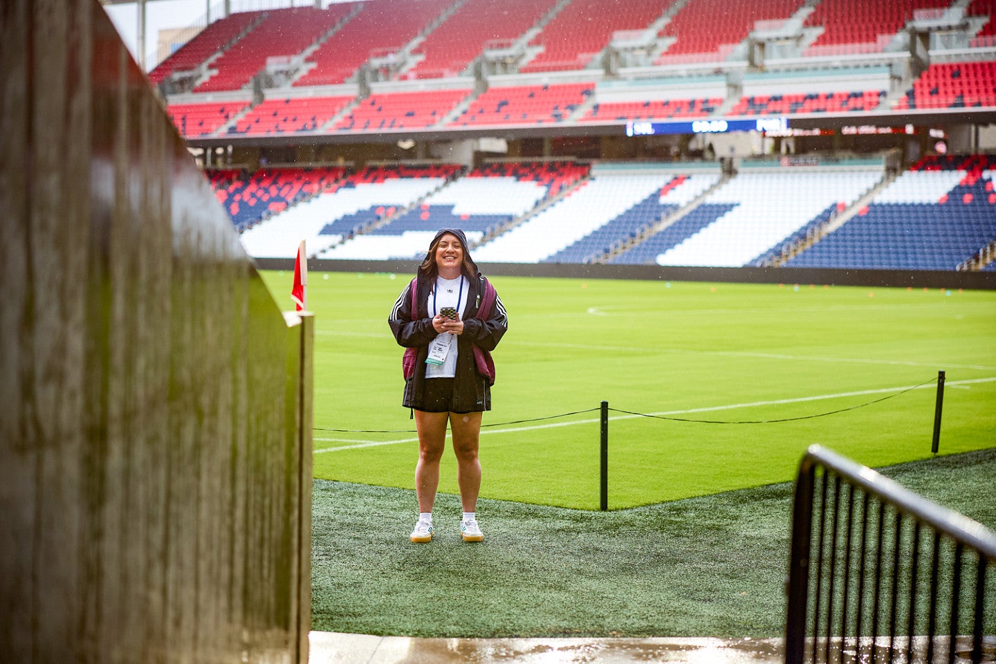 Vanesa Montalvo stands on the field at a large soccer stadium