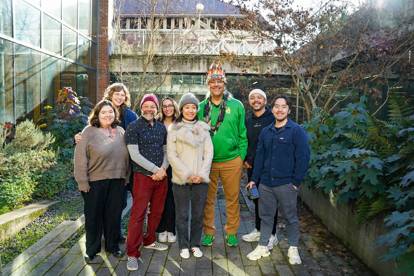 a group of people posing in an outdoor courtyard