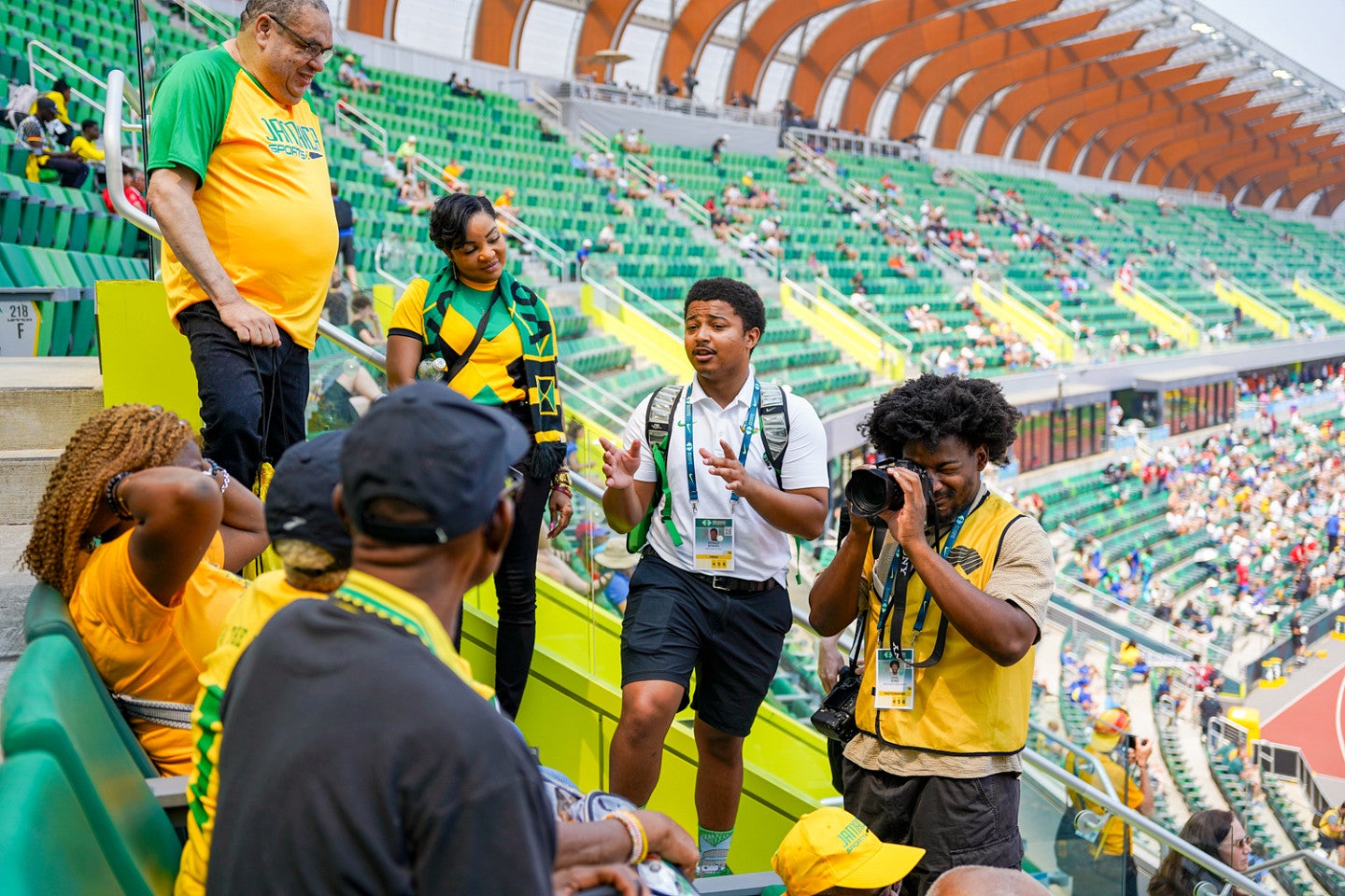 Two students interview and photograph fans at Hayward Field