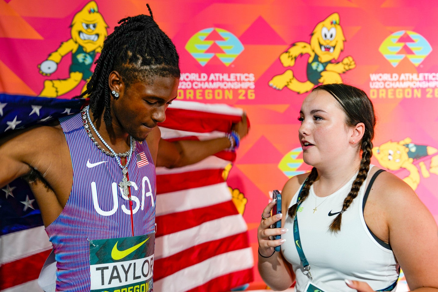 A student interviews a track athlete