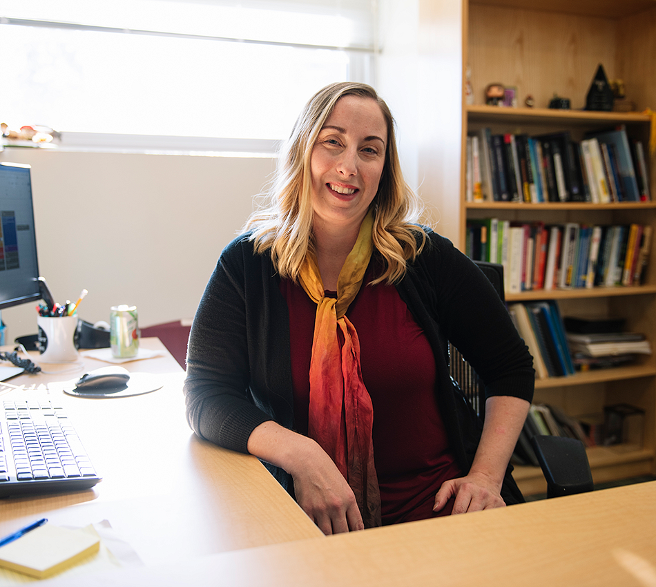 Autumn Shafer sits at a desk in her office