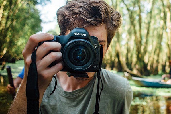 Student taking a photo Student taking a photo with a Canon camera