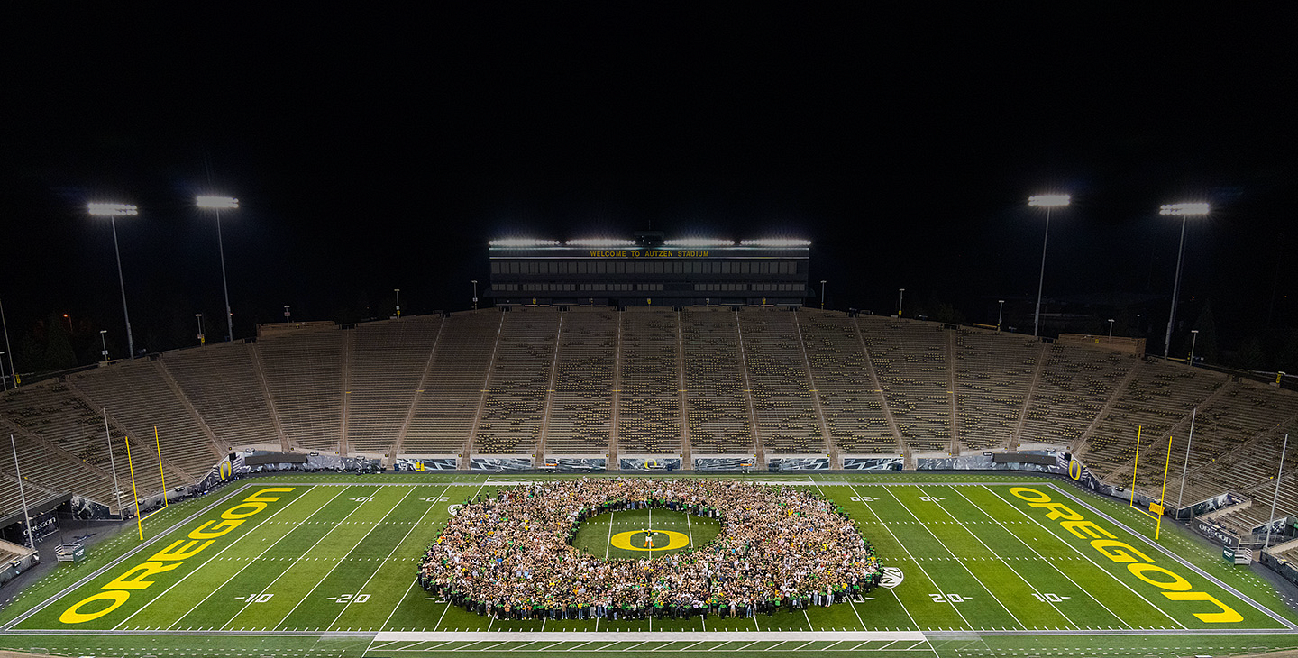 aerial view of UO class of 2025 students standing in the shape of an O on the Autzen Stadium field