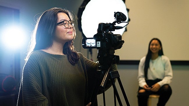Two students working in the UO Experience Hub production studio