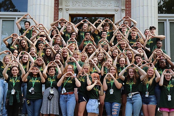 Students in the Next Gen Storytelling group throwing the O in front of Johnson Hall