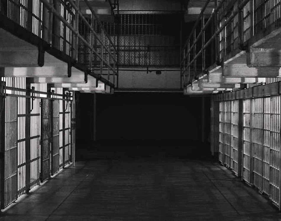 dramatically lit photo of a prison cell block