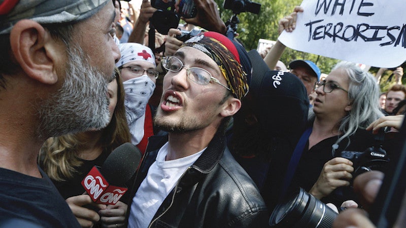 A supporter of President Donald Trump, center, argues with a counterprotester, left, at a "Free Speech" rally by conservative activists in 2017 in Boston. 