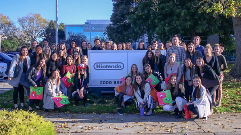 UO School of Journalism and Communication students in front of the Nintendo sign