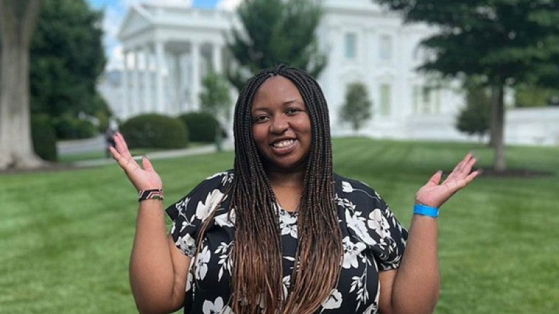 Polly Irungu stands in front of the White House