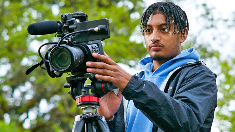 a student films with a video camera
