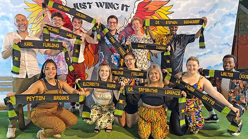 students on the Media in Ghana trip pose with custom woven sashes