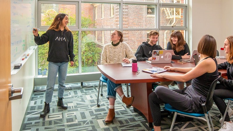 students in Allen Hall Advertising collaborate in a classroom