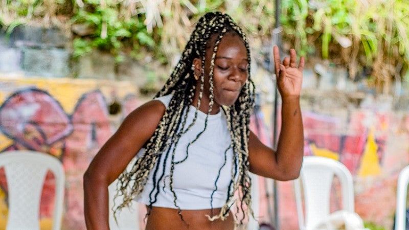 a woman with long braids dances