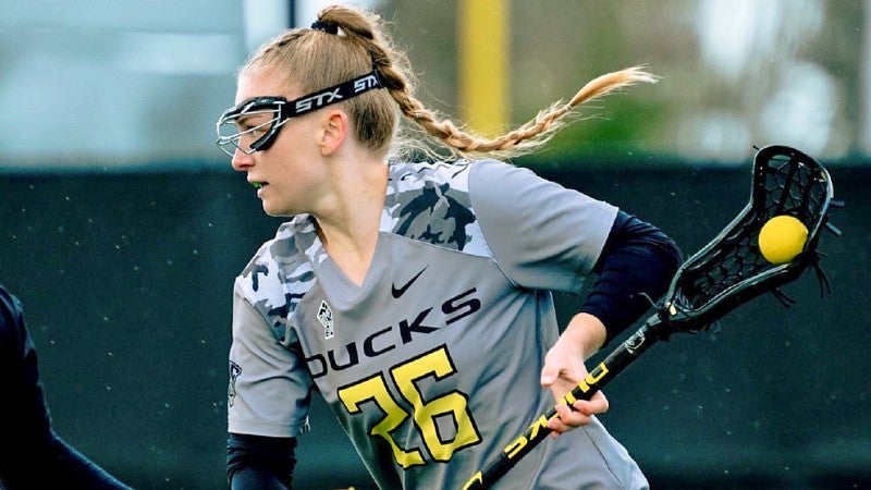 Bailey Smith playing lacrosse for UO