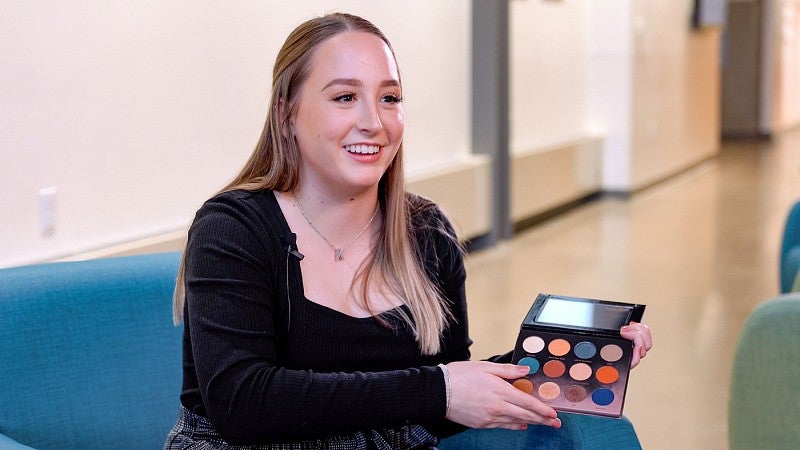 Kaitlyn Bullentini holding an eyeshadow palette