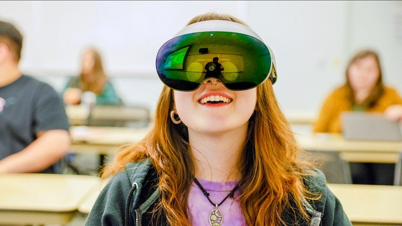a person wearing a VR headset with a vibrantly colored reflective surface