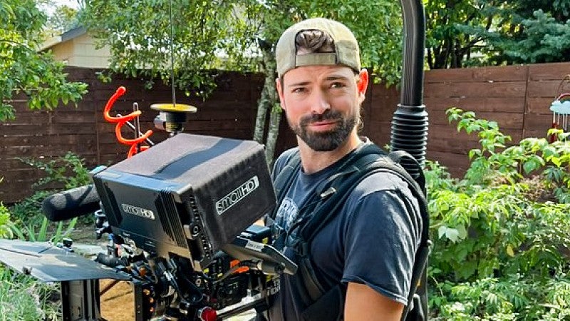 Kyle LaMontagne poses while wearing a large stabilized camera rig
