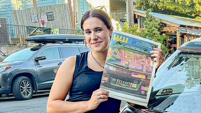 Eliza Aronson poses with a copy of Willamette Week newspaper