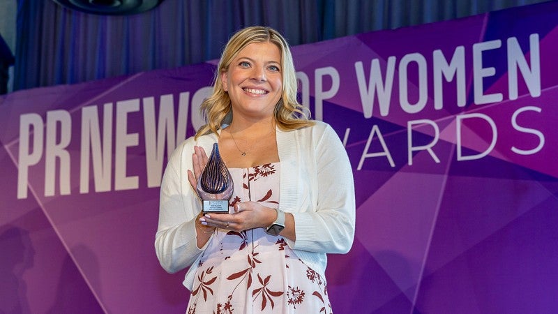 Hannah Oakley poses with her PRNEWS Top Woman in Communications Rising Star award in April 2025