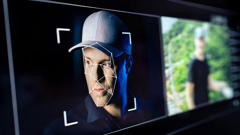 stock image showing digital face-mapping lines superimposed over a man's face