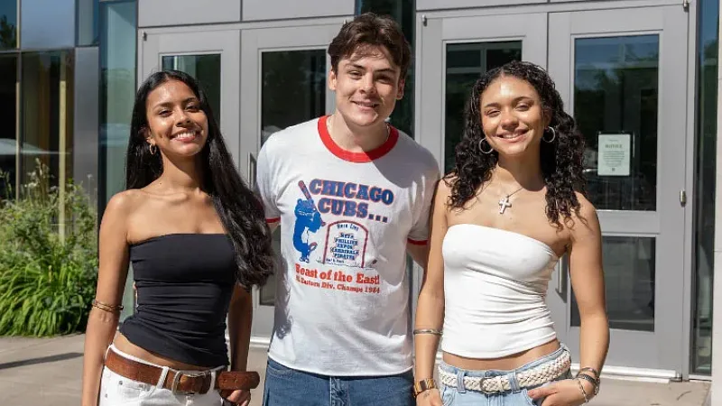 three University of Oregon students pose outside of the Erb Memorial Union