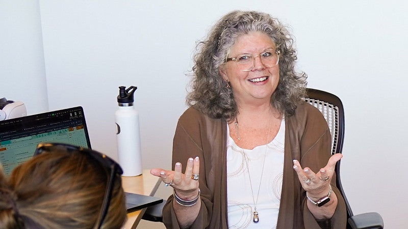 Donna Davis gestures to a student during a strategic communication master's program class at the University of Oregon School of Journalism and Communication in Portland