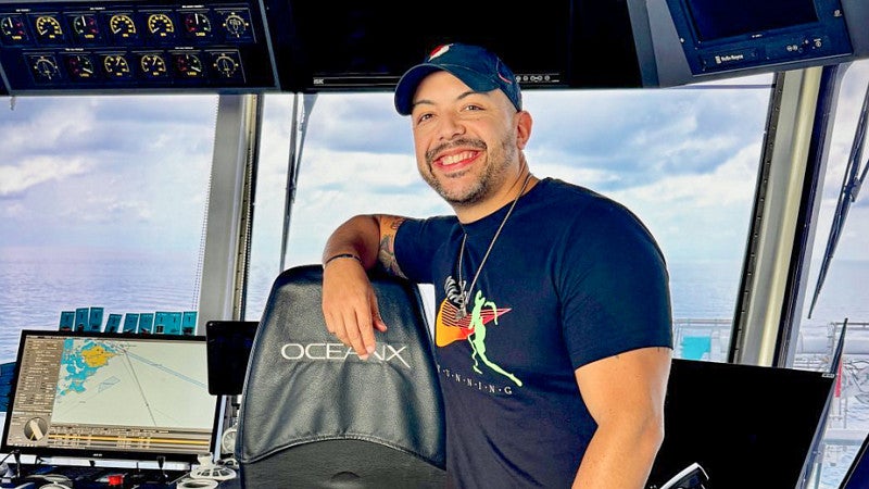 Danny Pimentel poses in the navigation space of the OceanX research ship