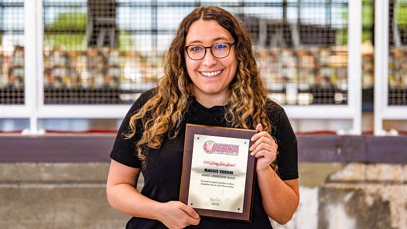 Maggie Vanoni poses with a plaque
